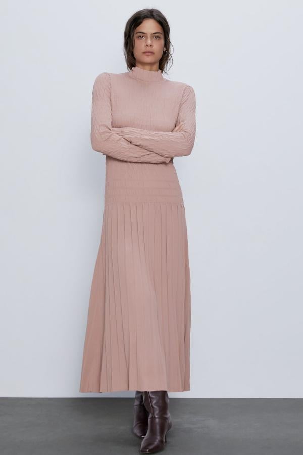 En color rosa palo, este vestido de punto con cuello subido y manga larga, es de Zara y cuesta 59,95 euros. Con acabado plisado en la falda, y detalle de elásticos tipo nido de abeja en el cuerpo, está disponible en las tallas S, M y L.