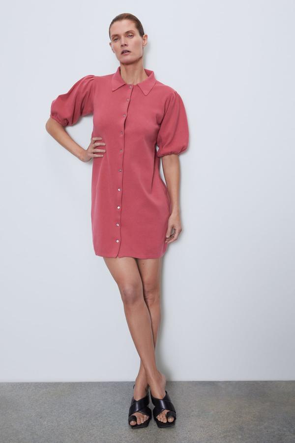 En color rosa fresa, este vestido corto de punto con cuello y solapa cuenta con manga corta abullonada acabada en elástico. Tiene un precio de 25,95 euros.