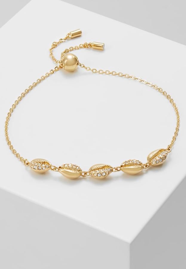 Pulsera bañada en oro con cristales engastados, de Swarovski (79,95 €)