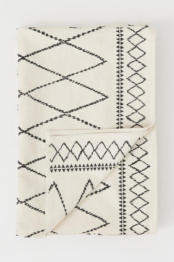 Con un tamaño de 145x200 centímetros, este mantel beige con estampado en negro está confeccionado en 100% algodón y tiene un precio de 18,99 euros.