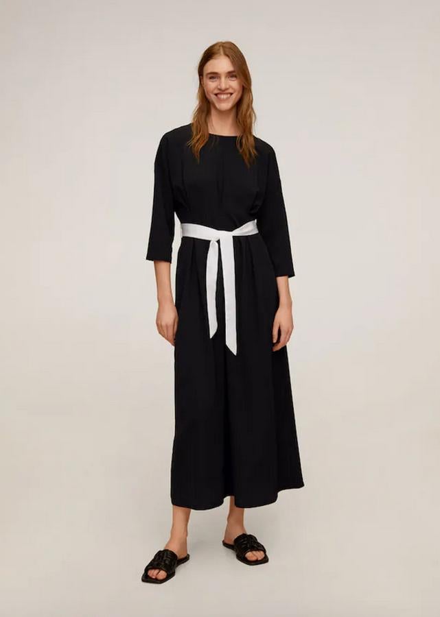 Diseño largo para este vestido negro de Mango con cuello redondo, manga tres cuartos y cinta a contraste en color blanco en la cintura con cierre de lazo. Con detalles drapeados, ha pasado de 49,99 euros a 17,99 euros y está disponible entre las tallas S y XL.