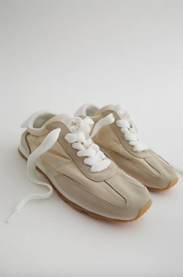 En blanco crudo, con combinación de materiales en el corte con detalle de pespuntes y lengüeta trasera, estas zapatillas de Zara con cierre de cordones tienen un precio de 35,95 euros y están disponibles entre los números 35 y 42.