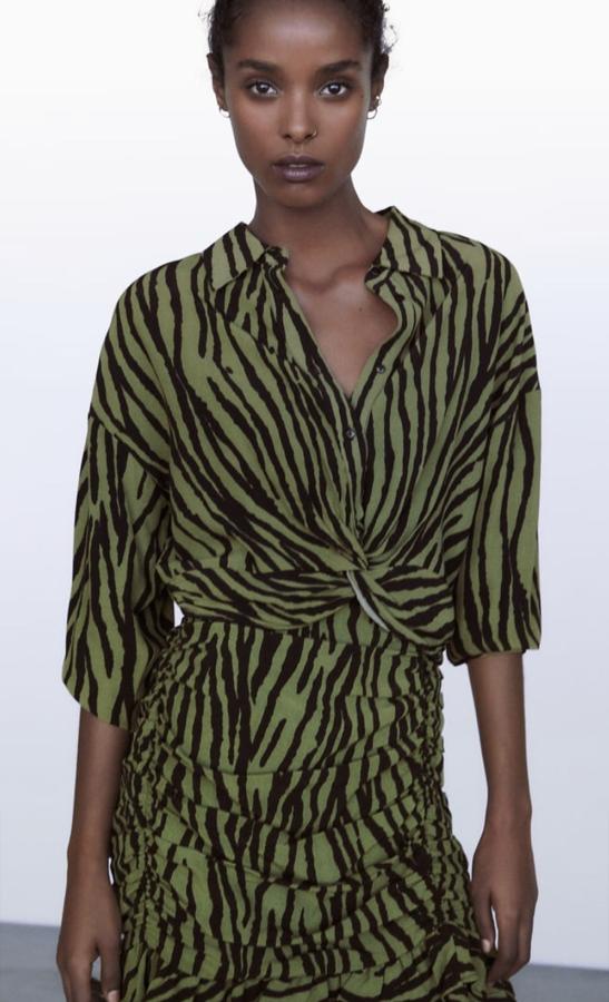 Conjunto de dos piezas compuesto por camisa cropped con nudo (25,99 euros) y minifalda drapeada (22,95 euros), en color verde, de Zara.