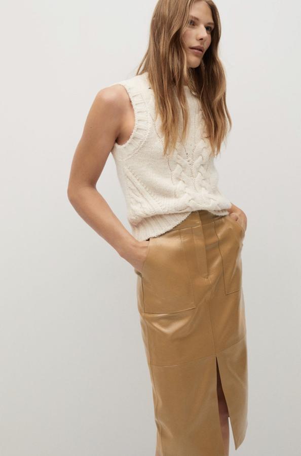 Con efecto piel pero muy brillante, como si fuera charol, este modelo de falda midi es de Mango (29,99 euros).