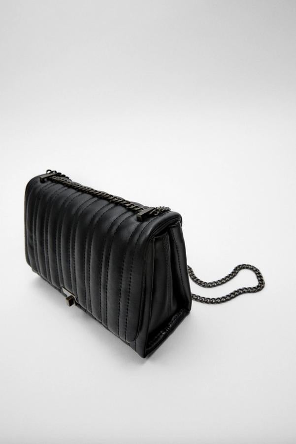 En formato bandolera, con cuerpo acolchado con pespuntes, este bolso negro viene con asa de hombro en cadena ajustable a tono. Con cierre de pieza metálica, costaba 29,95 euros y ahora podemos comprarlo por 19,99 euros.