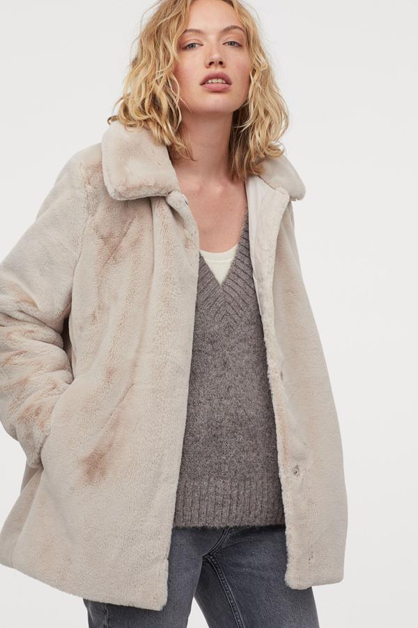 Disponible en beige claro y en gris oscuro, este abrigo corto en pelo suave con cuello, botones a presión ocultos en el frontal y bolsillos en las costuras laterales es de H&M y tiene el corte recto. Cuesta 59,99 euros y está disponible entre las tallas XS y XXL.