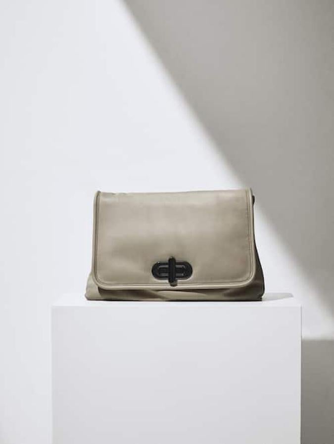 Con asa de mano extraíble y confeccionado en piel ovina y bovina, este bolso pouch con cierre de solapa con pieza metálica está disponible en beige, verde y negro. Pertenece a la colección edición limitada de la firma y cuesta 129 euros.