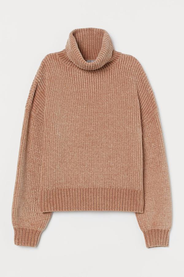 En punto suave de chenilla en color beige, este jersey oversize con hombros marcadamente caídos y puños y bajo en punto elástico de canalé, es de H&M y tiene un precio de 29,99 euros.