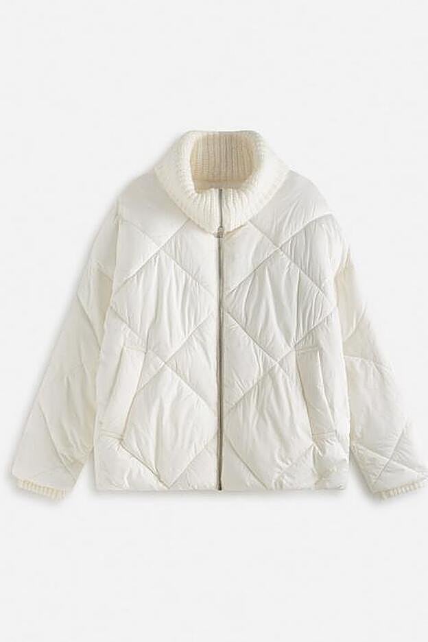 Esta chaqueta cuenta con bolsillos laterales y un calentito cuello alto de punto.