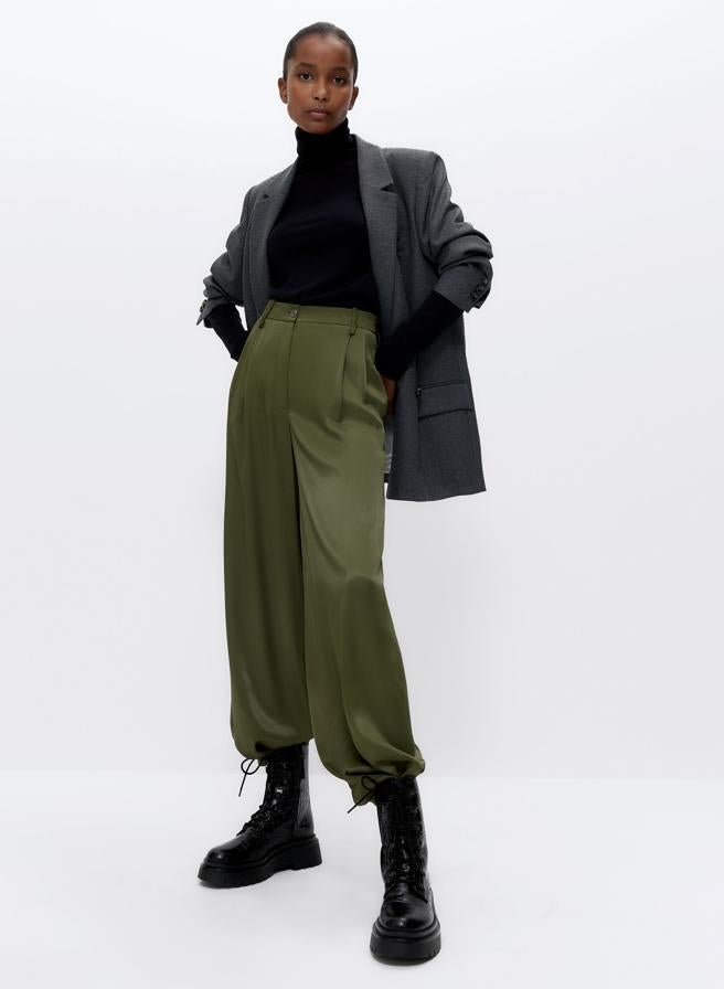 En color vede caqui, este pantalón fluido con efecto satinado cuenta con pliegues en la cintura y bolsillos laterales. Tiene un precio rebajado de 49,95 euros.