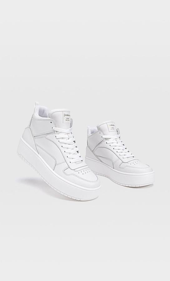Con detalle de piezas, pespuntes y perforados, estos botines deportivos de Stradivarius tipo basket en color blanco tienen un precio de 29,99 euros y están disponibles entre los números 35 y 41.
