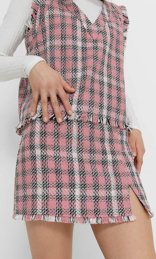 Para completar el look Stradivarius ha lanzado esta falda mini con bajo desflecado y abertura lateral con estampado de cuadros en rosa chicle, negro y blanco. Disponible entre las tallas 34 y 44, cuesta 19,99 euros.