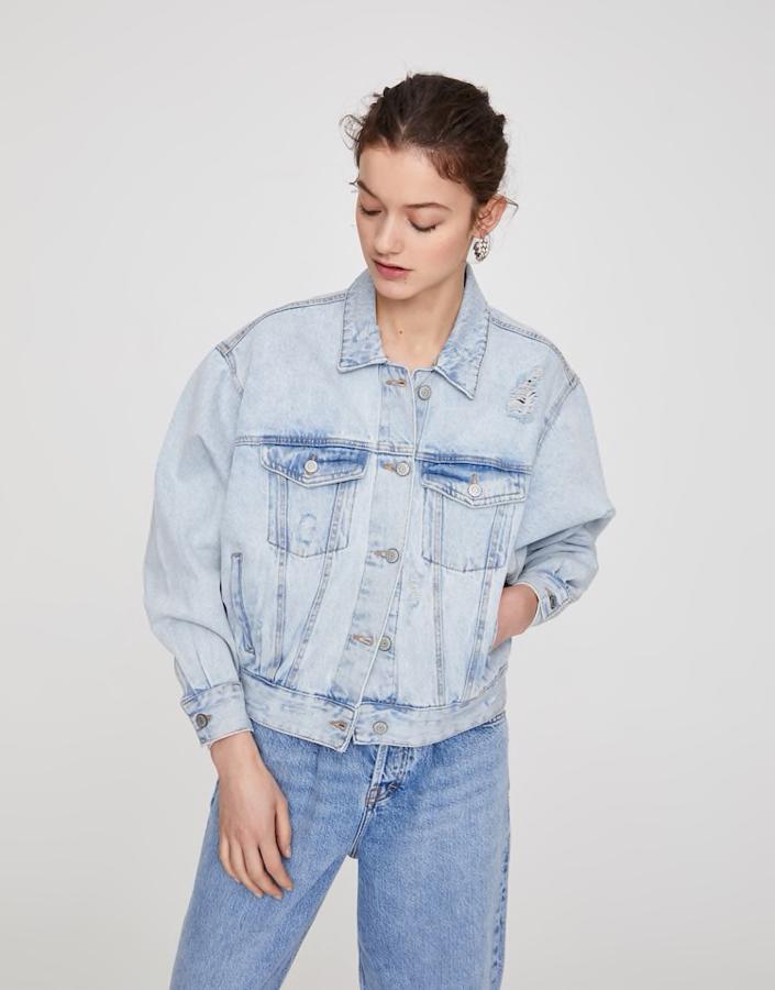 Cazadora vaquera de inspiración 80's, con cuello clásico, silueta oversize, manga larga, cierre de botones, bolsillos delanteros y confeccionada en algodón, de las rebajas de Pull & Bear (9,99 €).