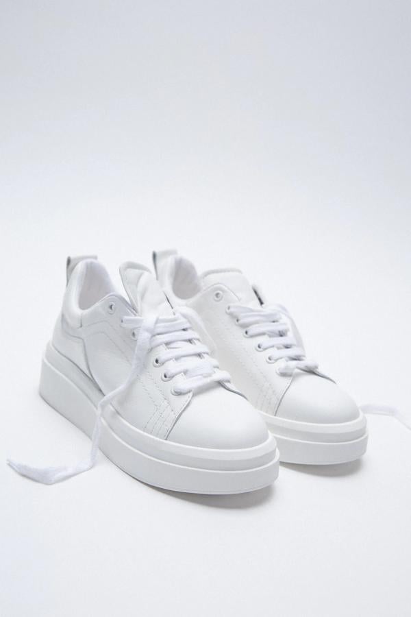 De piel en color blanco, estas sneakers con detalle de pespuntes y tirador trasero cuentan con suela gruesa con plataforma y cierre mediante cordones. Son de Zara y tienen un precio de 45,95 euros.