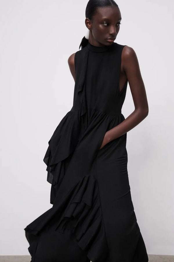 De cuello subido y manga sisa, este vestido negro con detalle de volantes en los laterales de la falda y en uno de los lados del cuerpo cuesta 29,95 euros y está disponible en las tallas S, M y L.