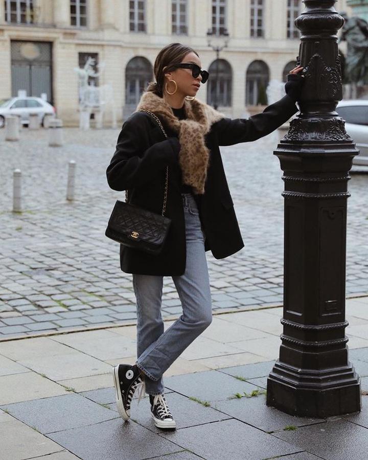 Abrigo básico de color negro + vaqueros rectos+ bolsos acolchado de Chanel + zapatillas Converse