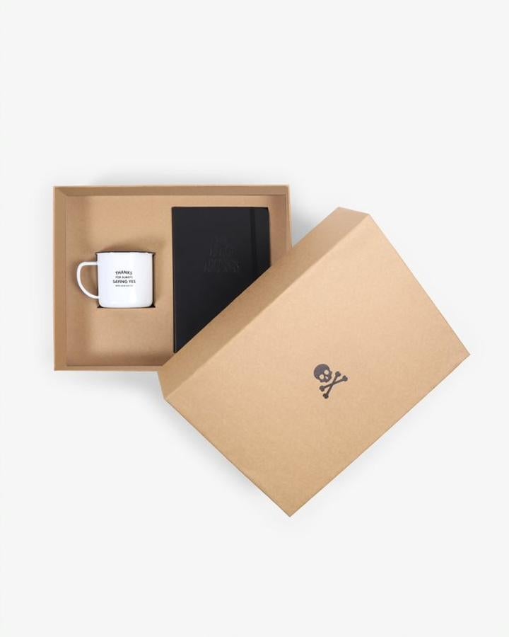 El pack día del Padre de Scalpers, con una libreta de piel y una taza con mensaje ("Gracias por decirme siempre sí cada vez que mamá decía no").