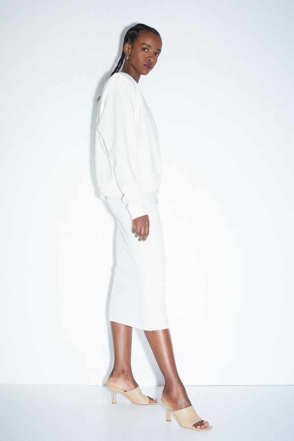 De diseño entallado, esta falda blanca de canalé, con talle alto y elástico oculto en la cintura es de H&M y está disponible entre las tallas XS y XXL por 12,99 euros.