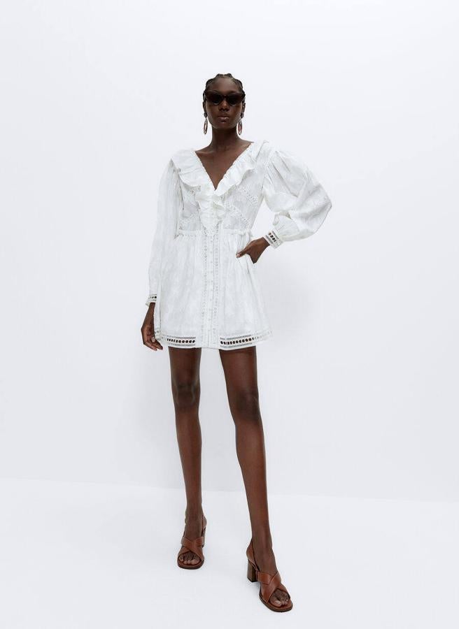 Minivestido de manga larga con escote de pico y volantes en el pecho, de Uterqüe (99 €).