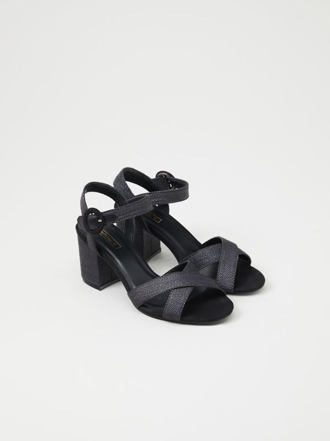 En color negro, con tiras cruzadas en el empeine y cierre de hebilla y pulsera en el tobillo, estas sandalias de tacón ancho de siete centímetros cuestan 19,99 euros y está disponibles entre los números 35 y 41.