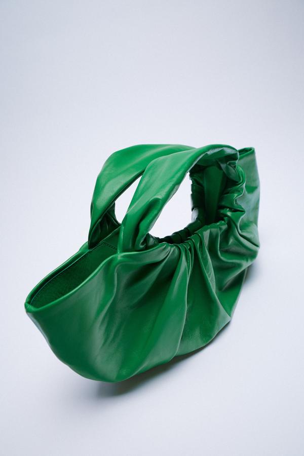 En piel de color verde, este bolso de mano formato saca con cuerpo con fruncidos y asas de mano tiene un precio de 79,95 euros.