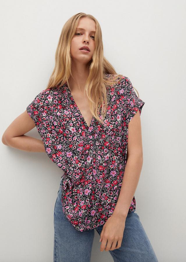 Con estampado de flores rosas y rojas sobre fondo negro, esta blusa de diseño oversize recto viene con mangas cortas y escote de pico. Tiene un precio de 19,99 euros y está disponible entre las tallas XS y XL. 