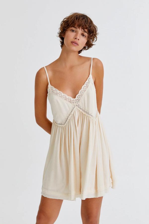 En color beige claro, este vestido lencero corto de tirantes finos y escote de pico cuenta con detalle de encaje y tiene un precio de 22,99 euros.