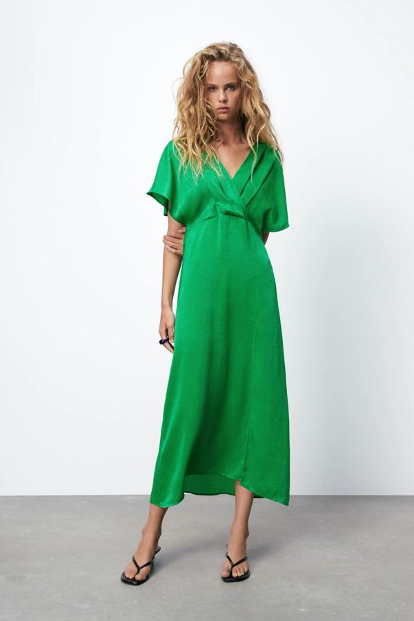 Con escote de pico cruzado con pliegues, este vestido de corte midi en color verde cuenta con manga corta y bajo con abertura. Tiene un precio de 39,95 euros.