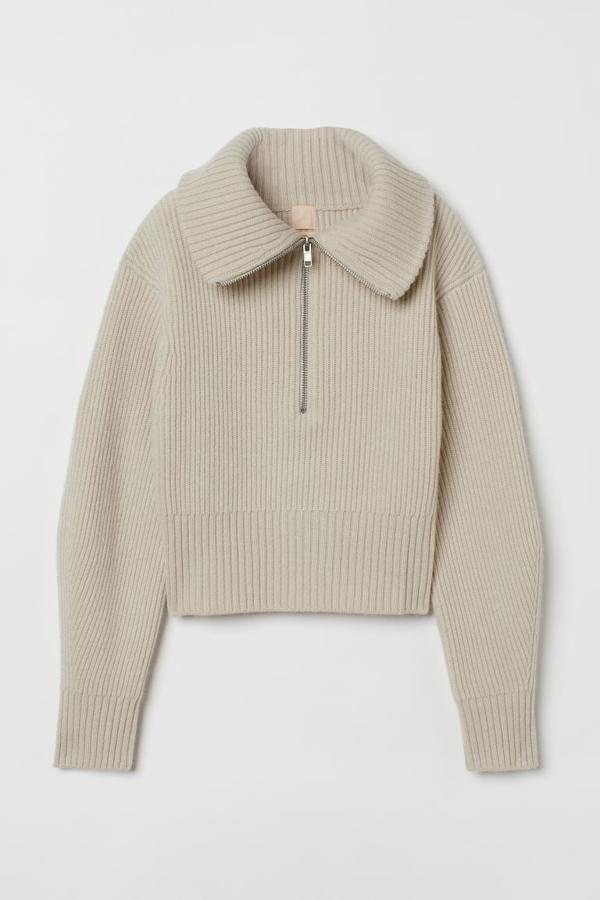 Sí o sí tienes que añadir un jersey con cuello tipo polo a tu colección de prendas de invierno. Este de color crudo con cremallera de H&M es una opción estupenda. Jersey corto de H&M (49,99 euros)