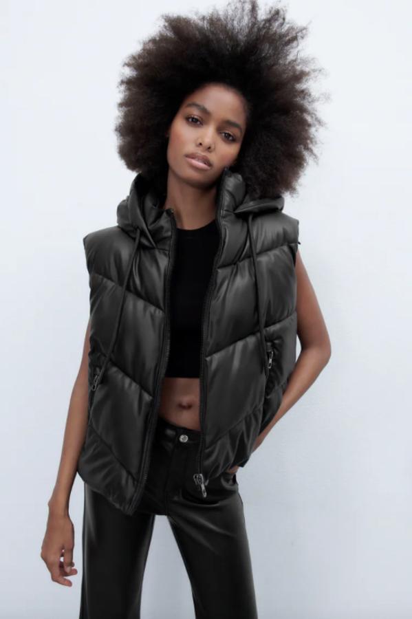 Con cuello subido con capucha y manga sisa, este chaleco acolchado en efecto piel y color negro viene con bolsillos delanteros con cremallera y bajo ajustable con cordones elásticos. Tiene un precio de 45,95 euros. 