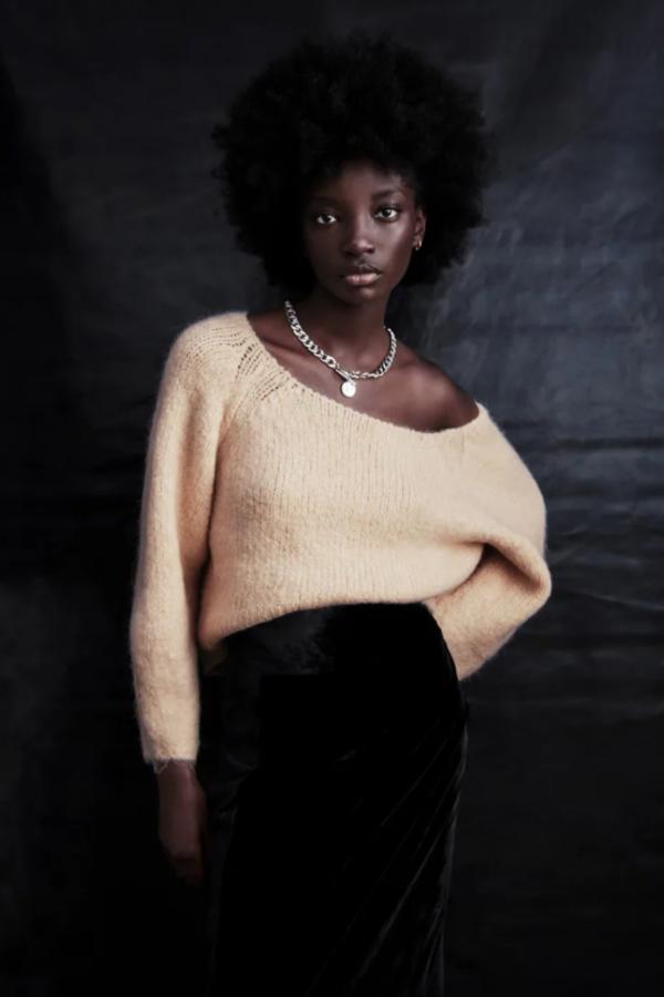 En color crema, con cuello redondo amplio y mangas largas abullonadas, este jersey de punto tiene un precio de 29,95 euros. 