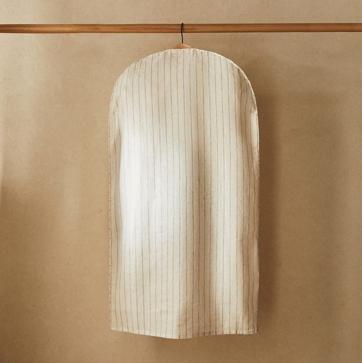 Imagen secundaria 1 - El portatraje de lino y piel cuesta 29.99 euros y las fundas de ropa de lino, lisas o con estampado de rayas, 19.99 euros el pack de dos.