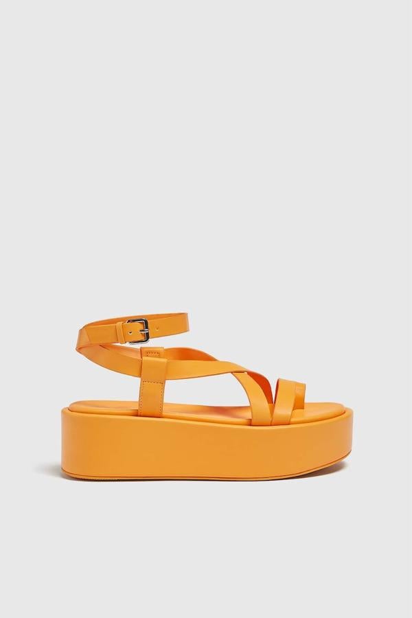 Sandalia de plataforma con tiras y cierre de pulsera al tobillo, de Pull&Bear. La puedes encontrar en naranja, azul y verde caqui con un coste de 35,99 euros.