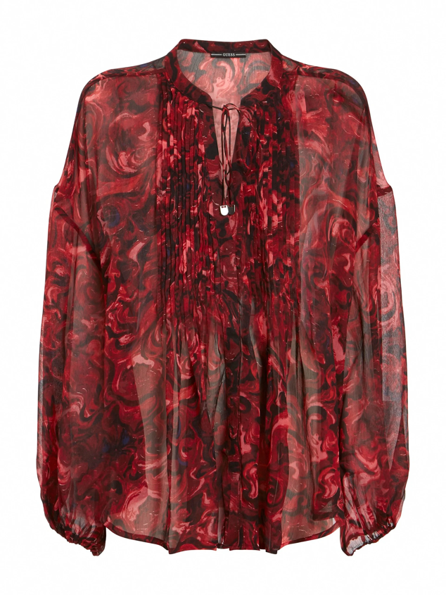 Blusa fluida de manga larga confeccionada en chifón de Guess. Cuenta con transparencias para originar un estilismo seductor y nocturno. Precio: 80 €. 