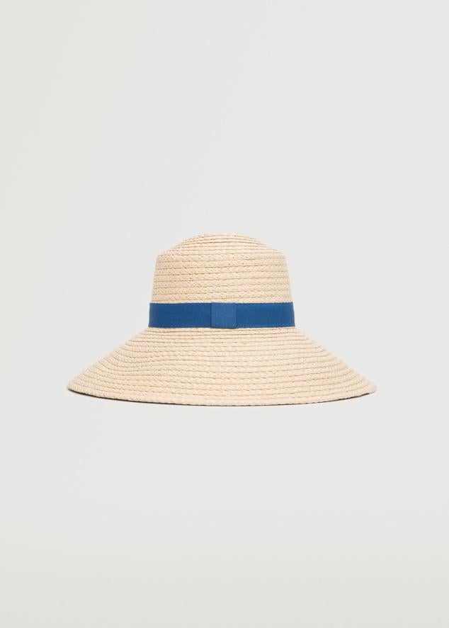 Los sombreros de rafia no puede faltar en ninguna maleta de vacaciones. Son el complemento perfecto para protegerse del sol durante las jornadas playeras y al mismo tiempo ponerle un toque estiloso al look. Sombrero con cinta azul de Mango (29,99 euros)