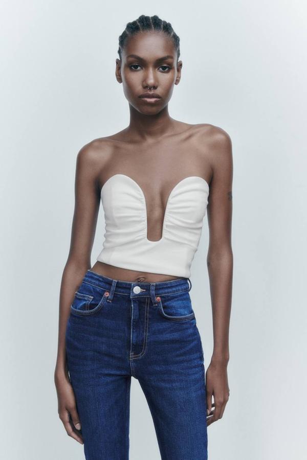 Top crop con escote corazón pronunciado, silueta entallada, detales fruncidos y hombros al descubierto. Cómpralo en blanco a 22,95 euros.