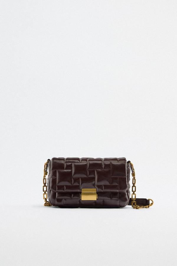 Aunque el negro es el rey de los tonos sobrios y elegantes, el marrón le hace la competencia. Bolso acolchado de Zara (25,99 euros). 