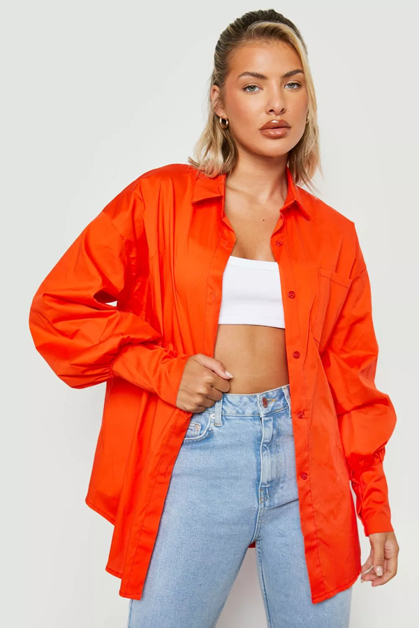 Camisa oversize de corte boyfriend en un color naranja vibrante. Cuentan con el detalle de tener los puños extra largos. Es de Boohoo. Precio: 38 €.