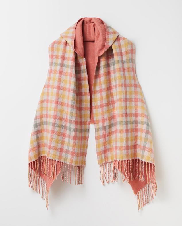 Poncho de cuadros vichy en tonalidades pastel con flecos de los mismos colores. Es de Sfera, aunque puedes conseguirlo en El Corte Inglés. Precio: 17,99 €. Cómpralo aquí
