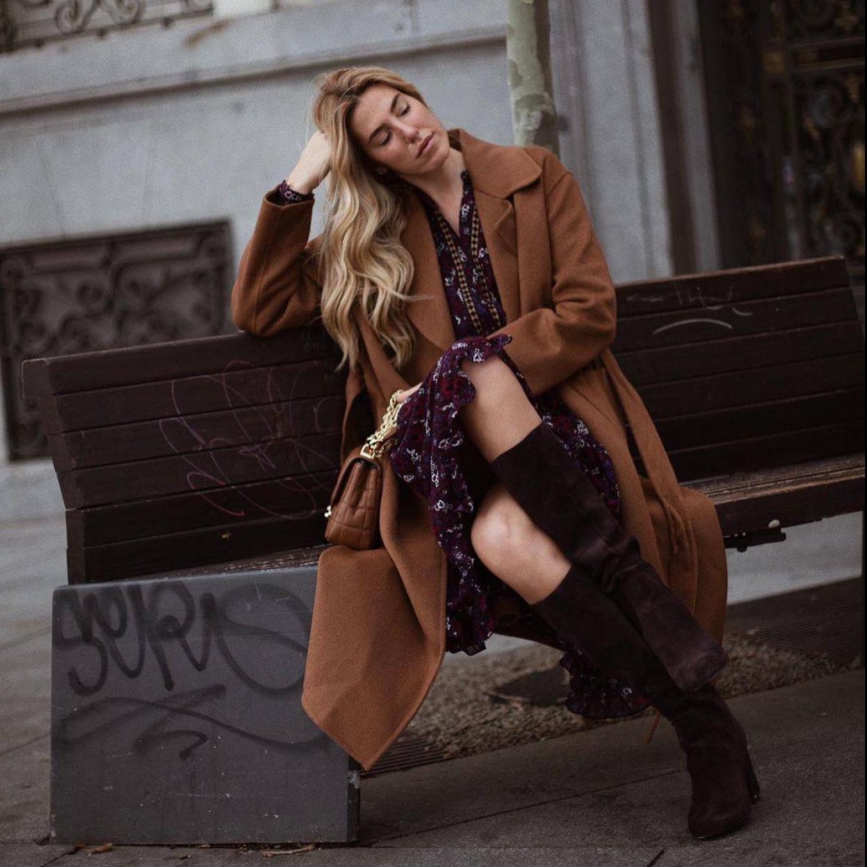 La influencer lleva un look con falda midi vaporosa y botas altas de tacón