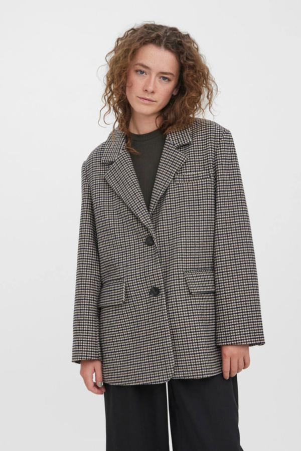 Blazer larga en tejido con lana y print de cuadros, cuello solapa con muesca, corte masculino, manga larga, tres bolsillos y cierre de botones, color marrón oscuro, de Vero Moda. Encuéntrala en Cortefiel a 69,99 euros.