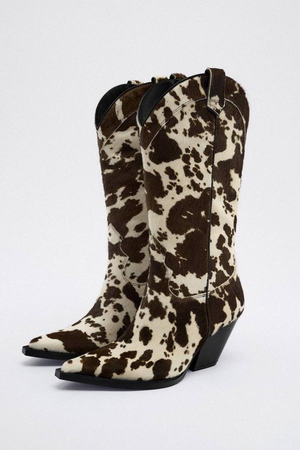 Botas cowboy en tejido de piel efecto pelo con tacón ancho, terminación en punta y animal print de vaca, en crudo y marrón, de Zara. Cuestan 149 euros.