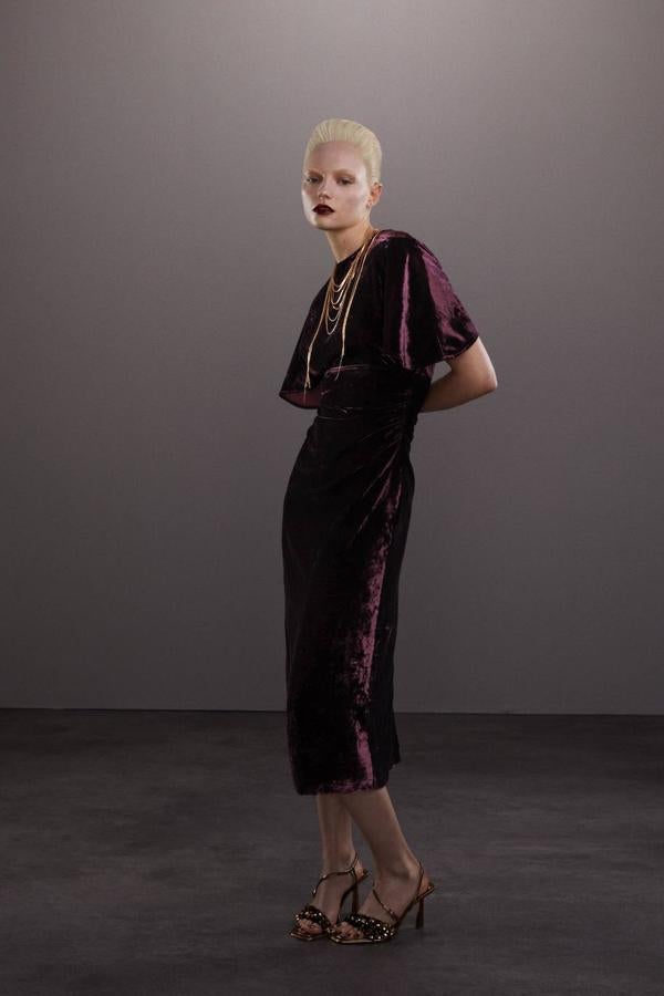 Vestido midi en tejido de terciopelo con mangas cortas amplias y cuello redondo, tono burdeos. Encuéntralo con descuento a 29,99 euros.