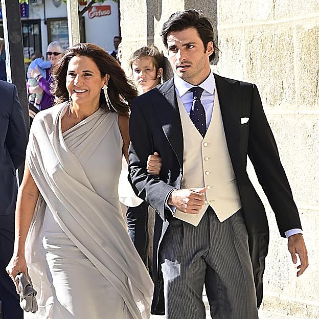 Carlos Sainz Jr. llega a la boda del brazo de su madre Reyes. 