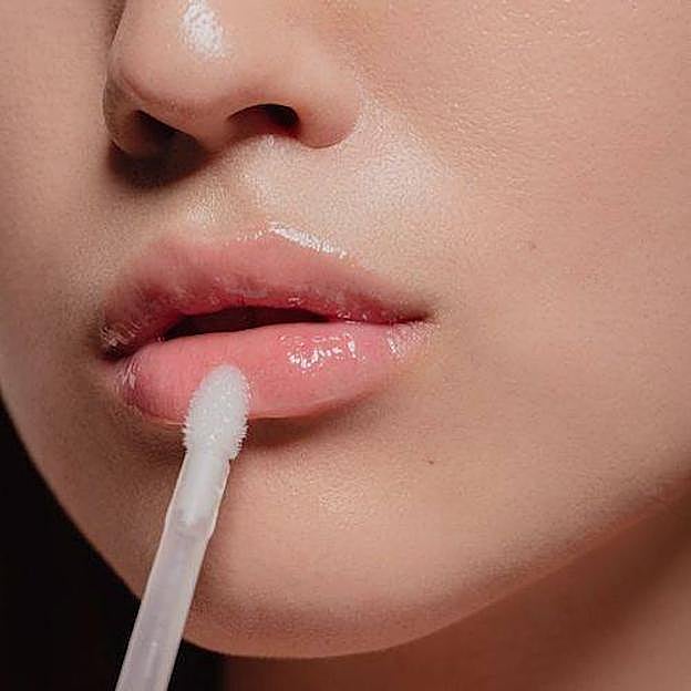 Mujer usando voluminizador de labios