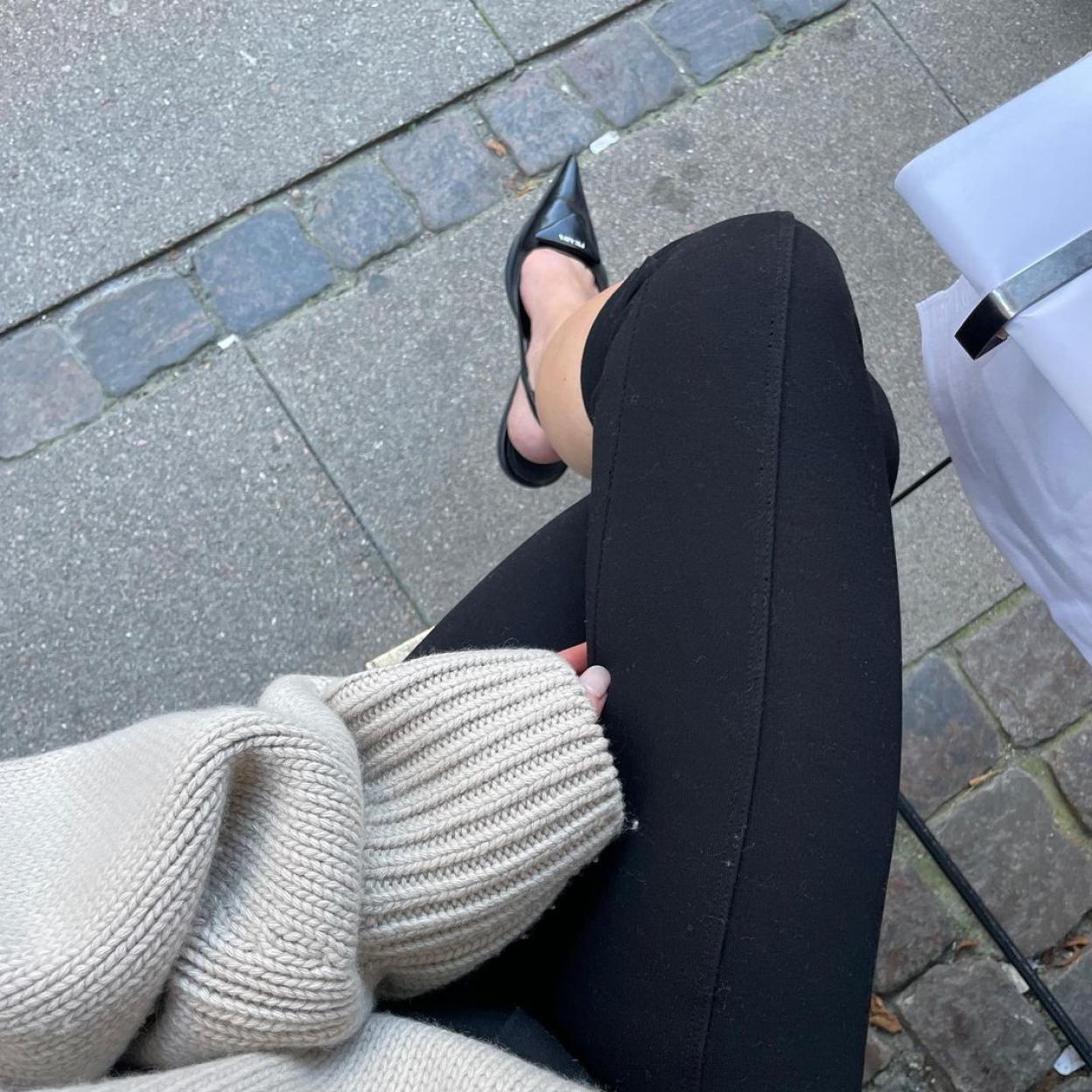 Una mujer con leggings negros.