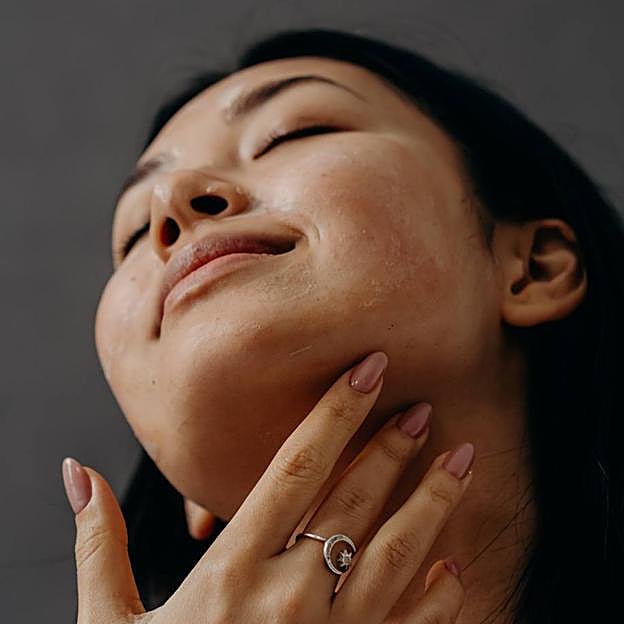 Mujer aplicando crema en el rostro