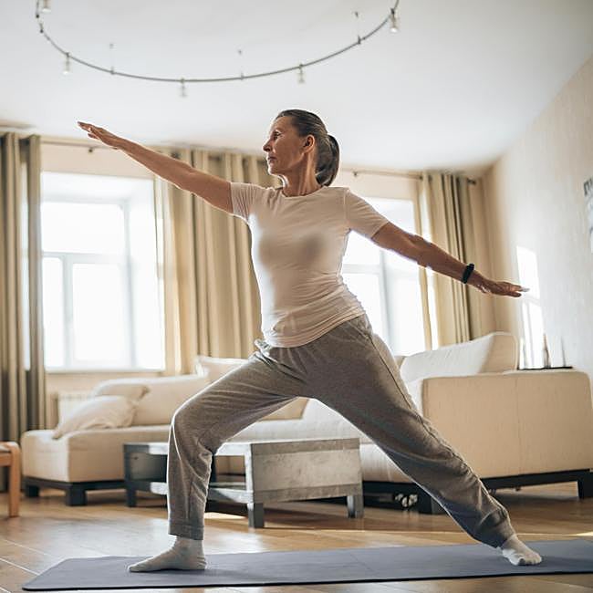 Mujer haciendo ejercicio de piernas en casa.