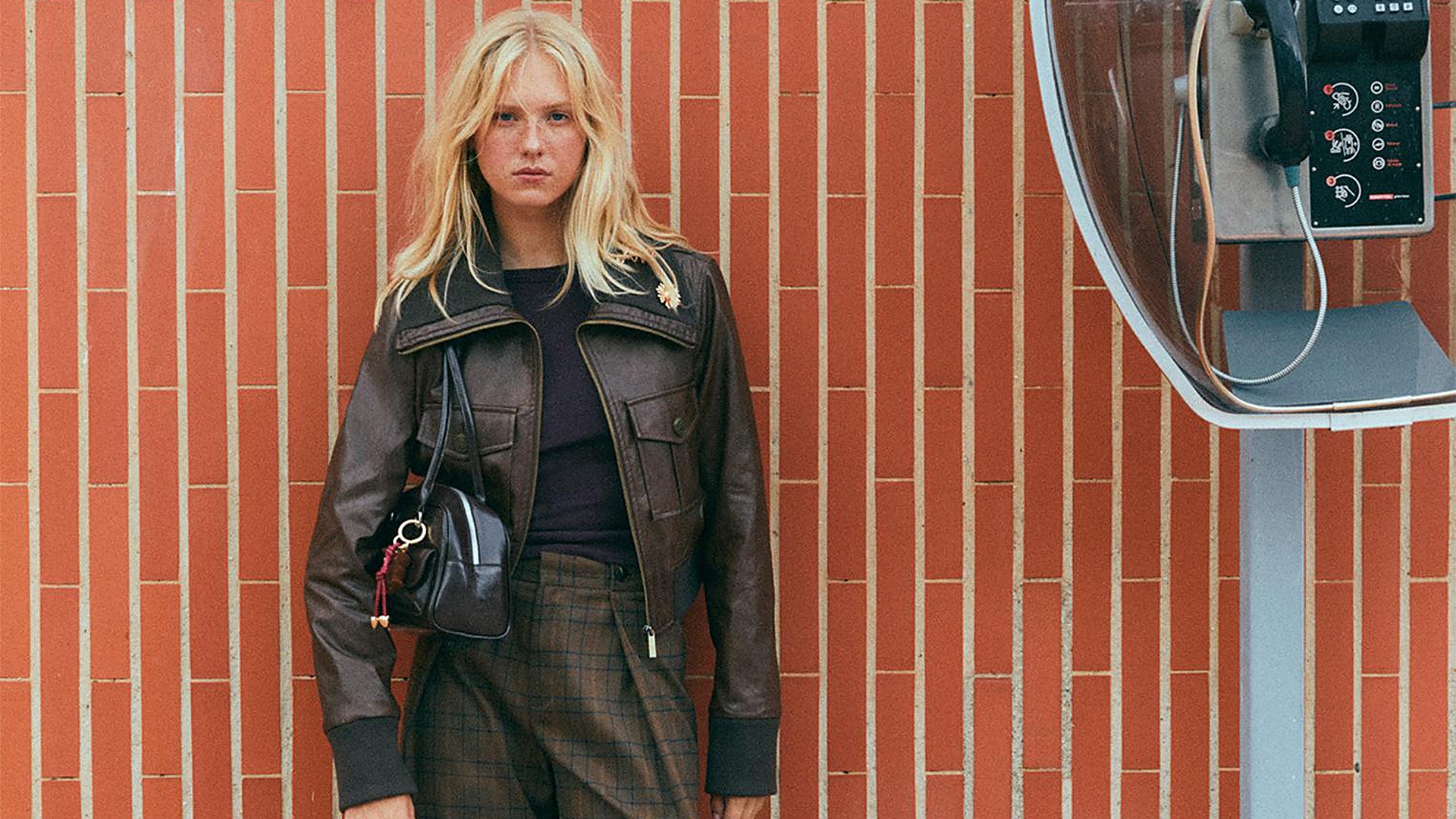 A woman in a striking black dress standing alone