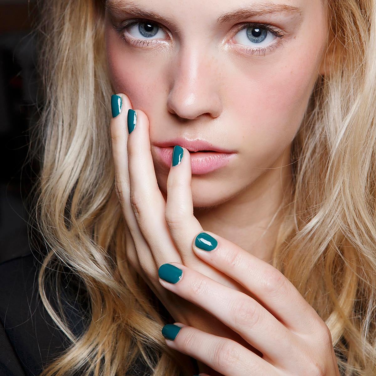 Una modelo con uñas verdes.